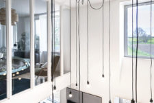 07 A modern and industrial chandelier highlights the height of the ceiling and brings more light to the bedroom above
