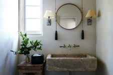 07 The bathroom is done with a stone sink, a wooden stand and bucket and some traditional sconces