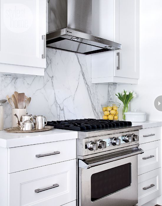 a cool sleek marble backsplash for an eye-catchy touch in a white kitchen