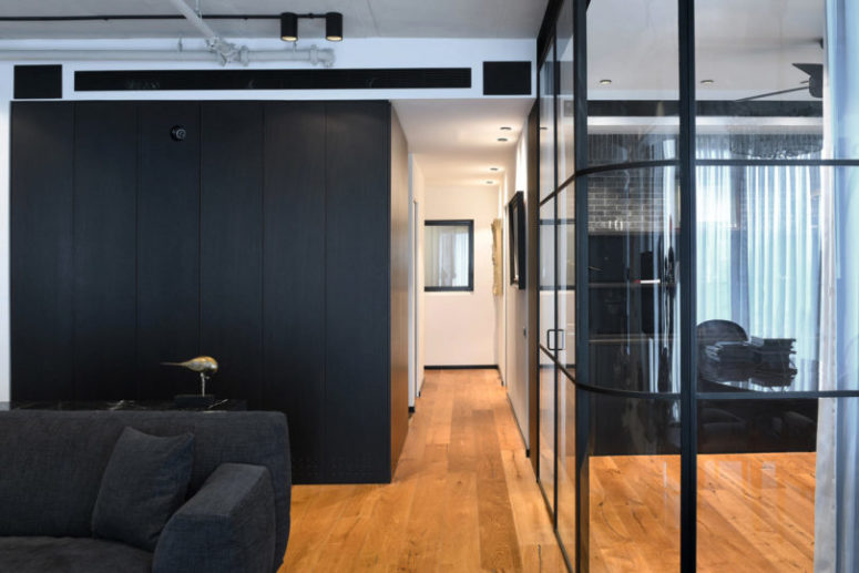 The bedroom cube is clad with dark wood on the outside