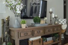 08 a rustic vintage console table styled with potted greenery and fresh blooms