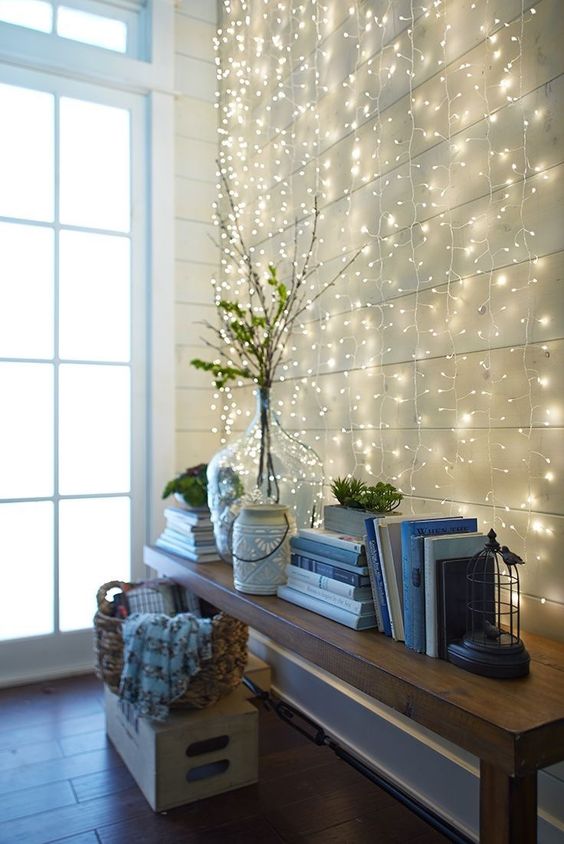 a whole wall with string lights hanging makes the entryway magical and cute