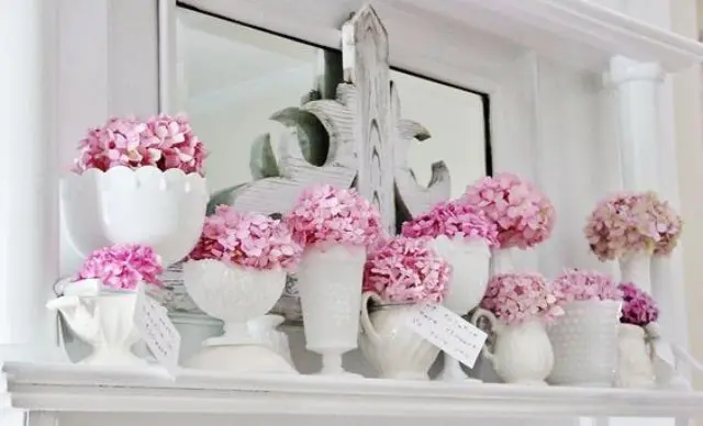 pink blooms in vases and jars of different look for a shabby chic spring mantel