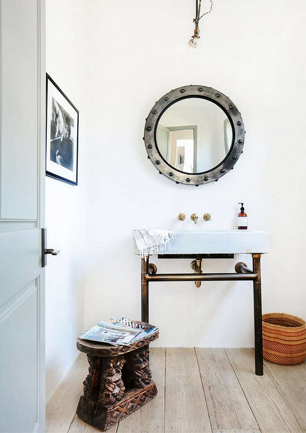 A guest bathroom features chic industrial touches   avanity and a mirror were custom made