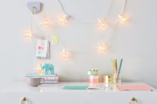 09 a chic small desk with pastel touches and cute lantern string lights over it