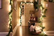 09 cover the door and archways with string lights to make it shine, here they are combined with faux fir garlands for the holidays
