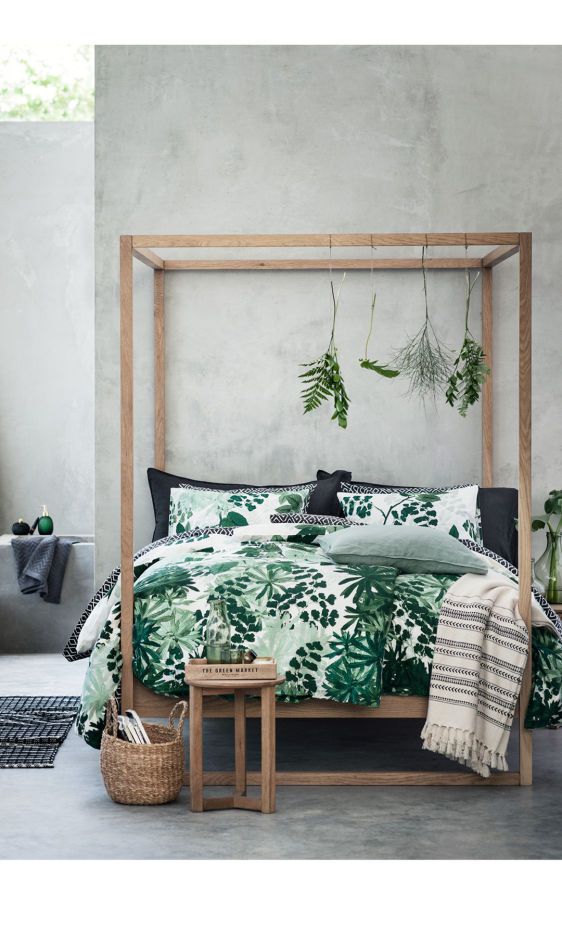 greenery bedding set and some herbs hanging on the bed frame for a fresh spring look