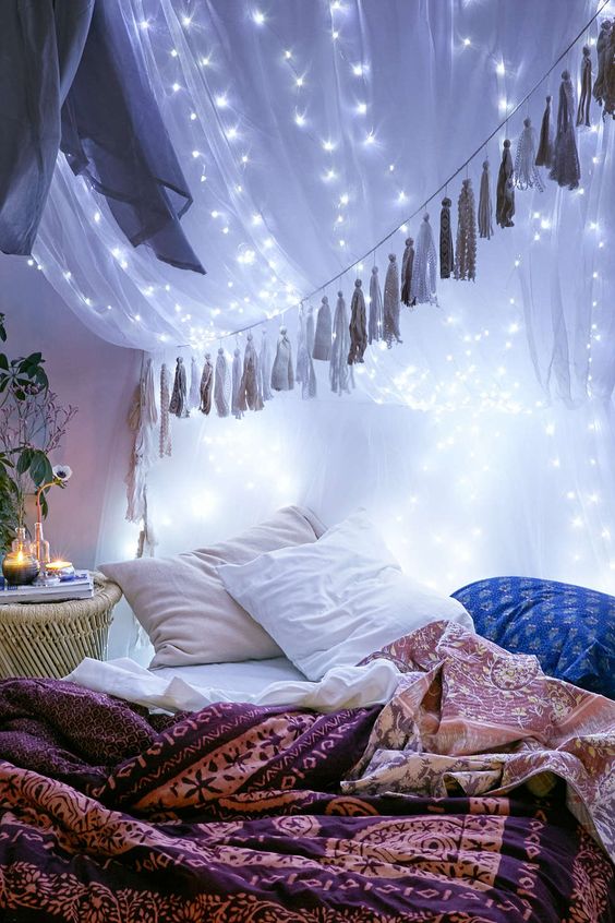 string lights attached to the bed canopy create a galaxy-like effect and look wow