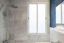 10 Marble is seen in the other part of the bathroom, too, and there’s much light in the space