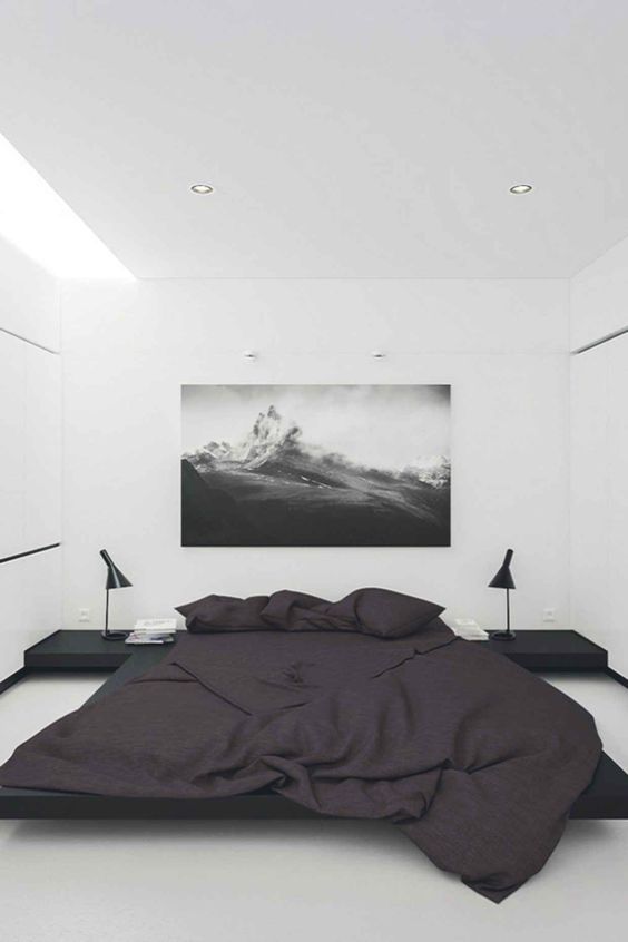 a minimalist bedroom in black and white with lots of negative space for a relaxed feeling