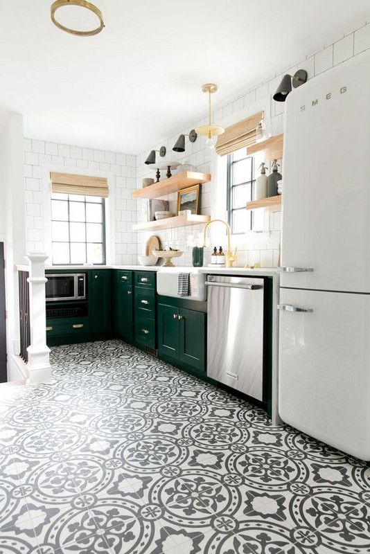 The kitchen is made more eye catching with black and white patterned tiles on the floor