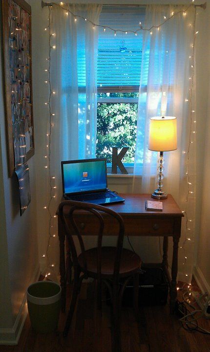 a tiny workspace by the window with string lights to enlighten it better