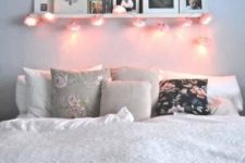12 a ledge over the bed with photos and some string lights attached to it