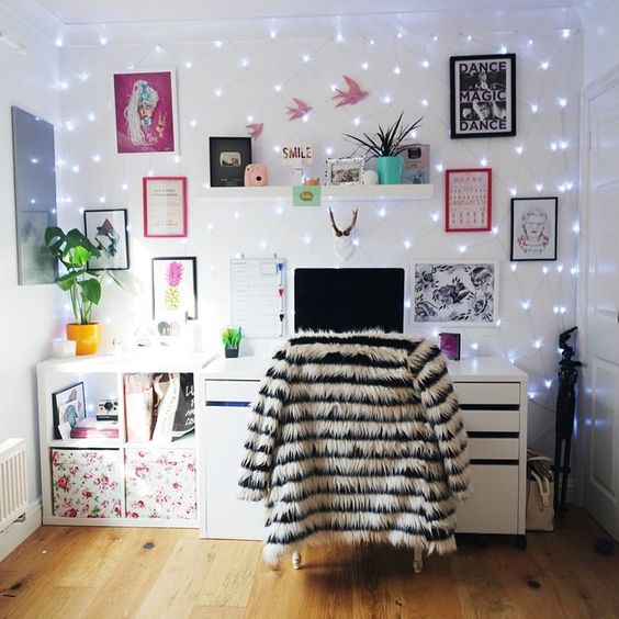 a whole wall covered with string lights makes the workspace glam, personalized and enlightened, no lamps needed
