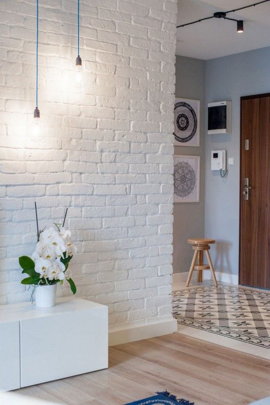 make the entryway more interesting with exposed white brick walls