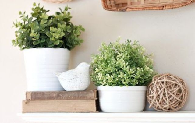 potted greenery in white planters is all that you need for a fresh spring mantel