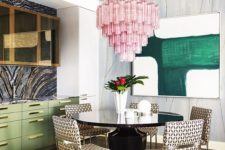 12 the dining space is highlighted with an oversized pink chandelier that contrasts the space