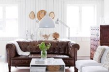 13 a modern farmhouse living room with vintage furniture and a brown leather Chesterfield
