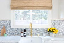 13 a neutral kitchen is spruced up with blue patterned tiles and brass touches