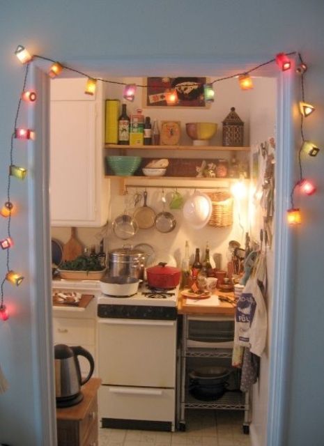 colorful vintage stirng lights that frame the kitchen entrance invite to mae in and make a cup of tea