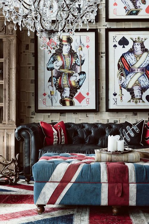 a whimsy and playful living room with a black leather Chesterfield sofa and a British flag ottoman