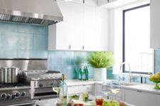 14 a white kitchen spruced up with light blue long tiles that stand out