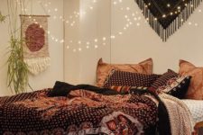 14 lots of string lights over the bedadd a magical feel to this boho bedroom
