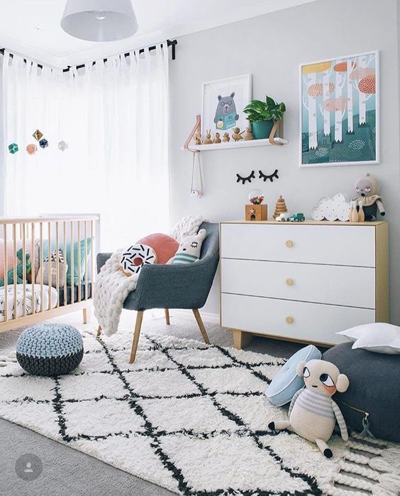 a gender neutral nursery filled with toys and with bright touches of colors