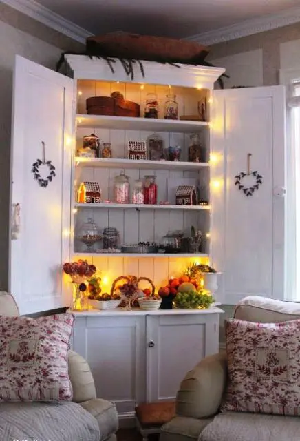 a vintage kitchen cabinet highlighted with string lights can be a display or some bar