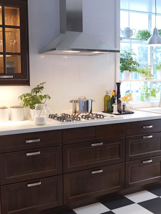 dark kitchen cabinets and large-scale white tiles for a contrast