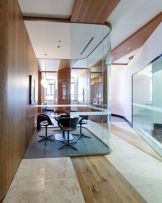 a meeting room inside a home with curved glazed walls