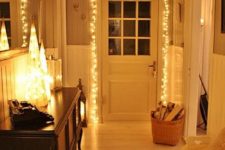 16 warm string lights cover the door and make the entryway more inviting and cute