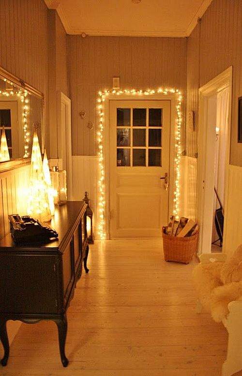 warm string lights cover the door and make the entryway more inviting and cute