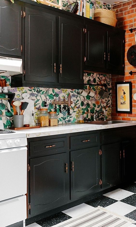 a kitchen backsplash done with floral wallpaper to stand out in a black kitchen