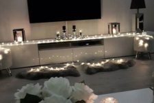 17 highlight your TV zone with string lights and maybe candles, this is a great way to accent