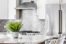 17 small scale silver tiles in a white kitchen for a bold and shiny touch
