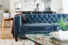 18 a farmhouse boho space with a muted blue Chesterfield sofa that works as a space divider, too