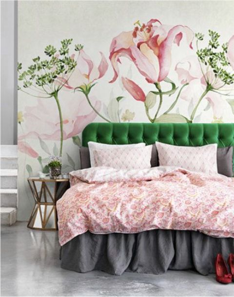 beautiful large blooms and greenery painted on the wall, a matching green bed and pink bedding