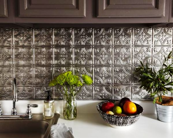 dark cabinets with silver metal hammered tiles that bring an Eastern feel to the space
