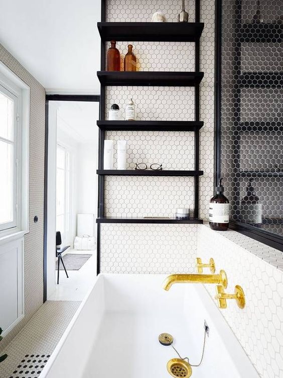 a black open shelving unit suspended over the sink