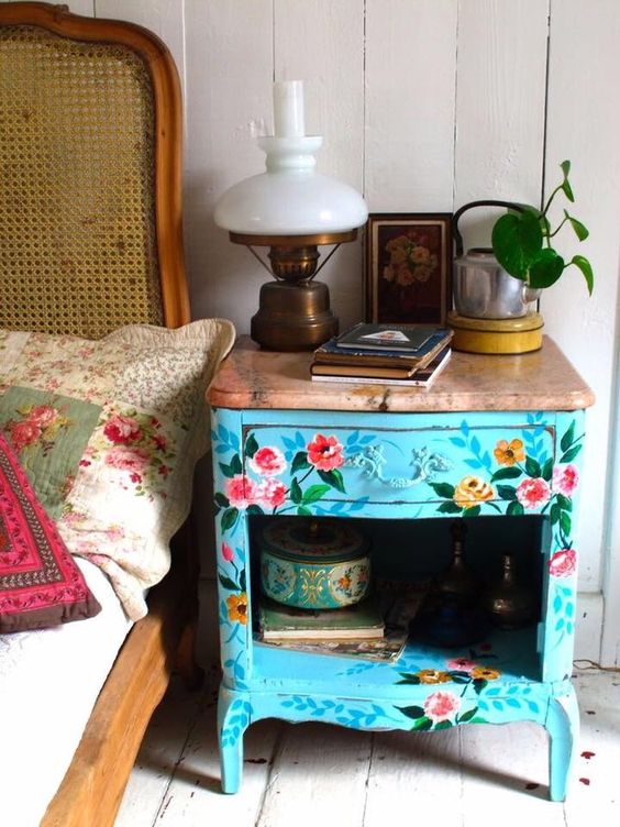 a blue vintage floral painted nightstand with a wooden top for a spring feel