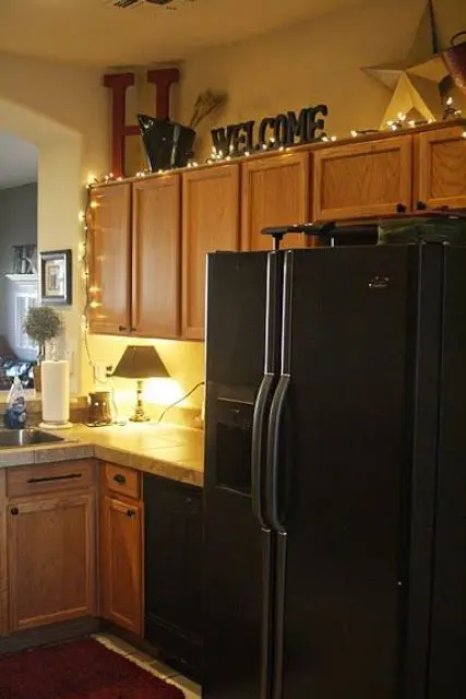 string lights going up the kitchen cabinets are a cute idea to try