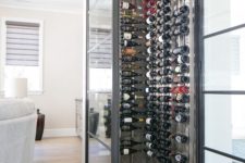 20 a chic small wine cellar highlighted with framed glass walls to keep a proper temperature inside
