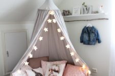 20 a cute tent for reading and playing with star-shaped string lights to add more light to the corner