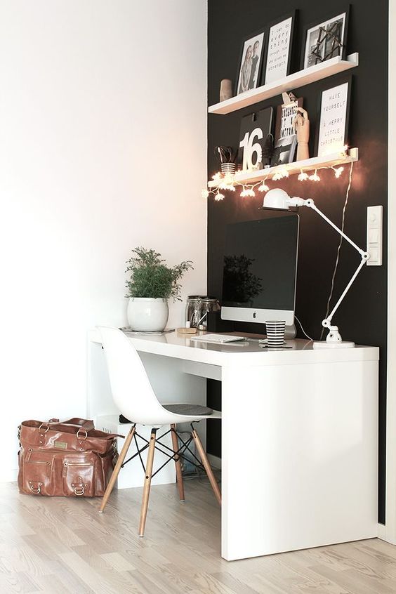 a minimalist workspace is made cuter and softer with floral string lights attached to the shelf