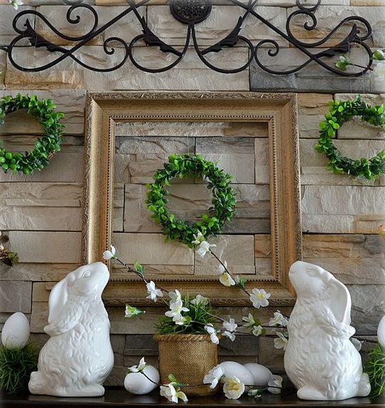 little boxwood wreaths, potted greenery, faux eggs and porcelain bunnies for a traditional mantel