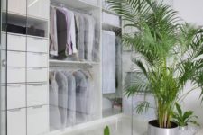 21 a minimalist closet done with white with glass walls and fresh potted greenery