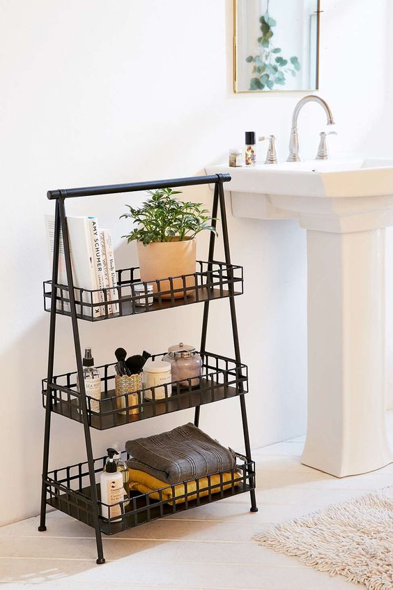 a three-tiered metal storage piece next to the sink is a comfy idea instead of a vanity