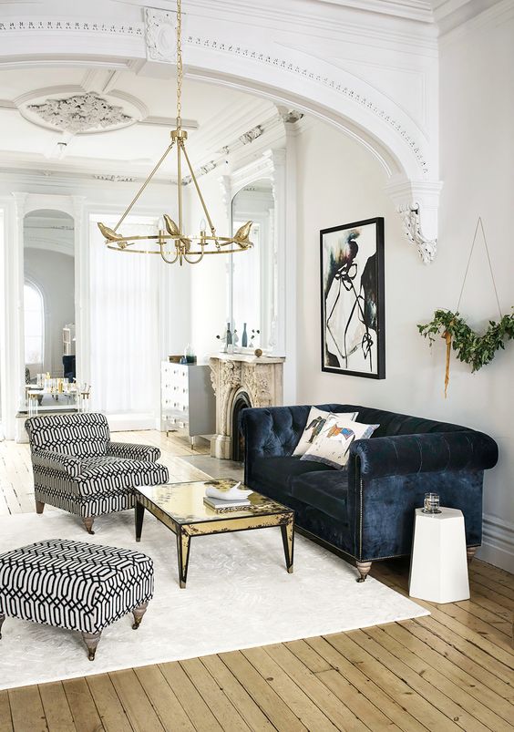 a refined space with shabby touches and a navy velvet Chesterfield sofa as a dark touch