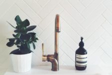22 clad a bathroom backsplash with long and narrow tiles in a chevron pattern